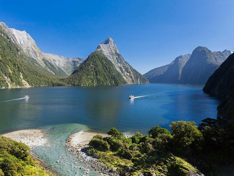 A delta of pale stones spilling into the fiord below steep green walls